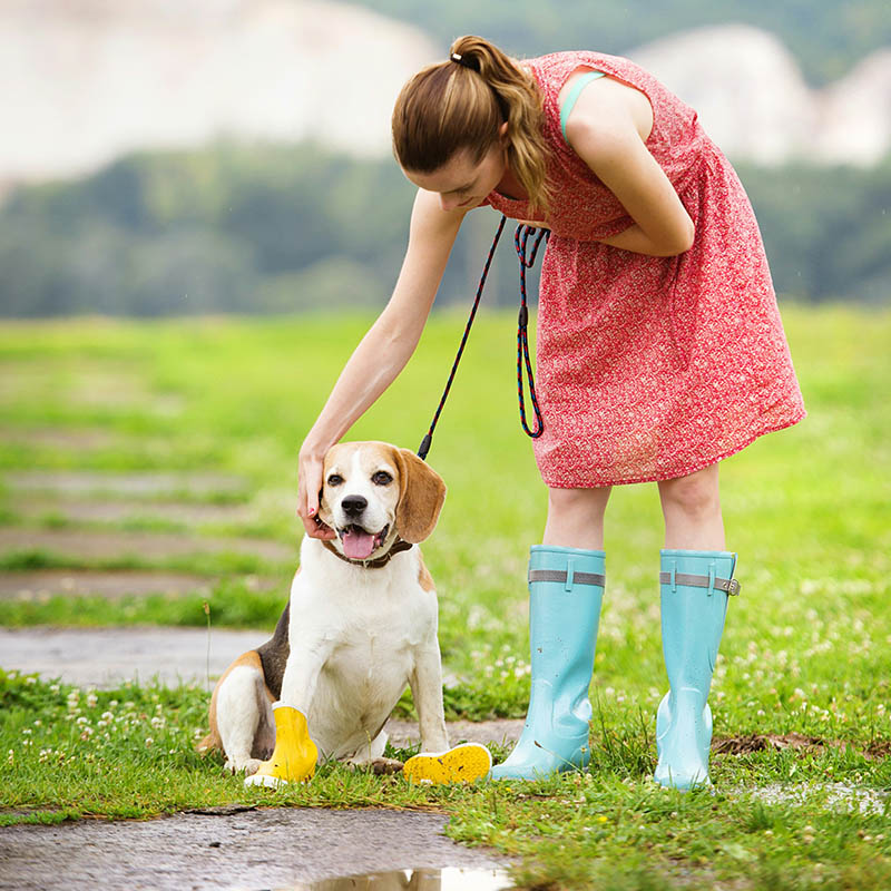 Girl in boots pets her dog